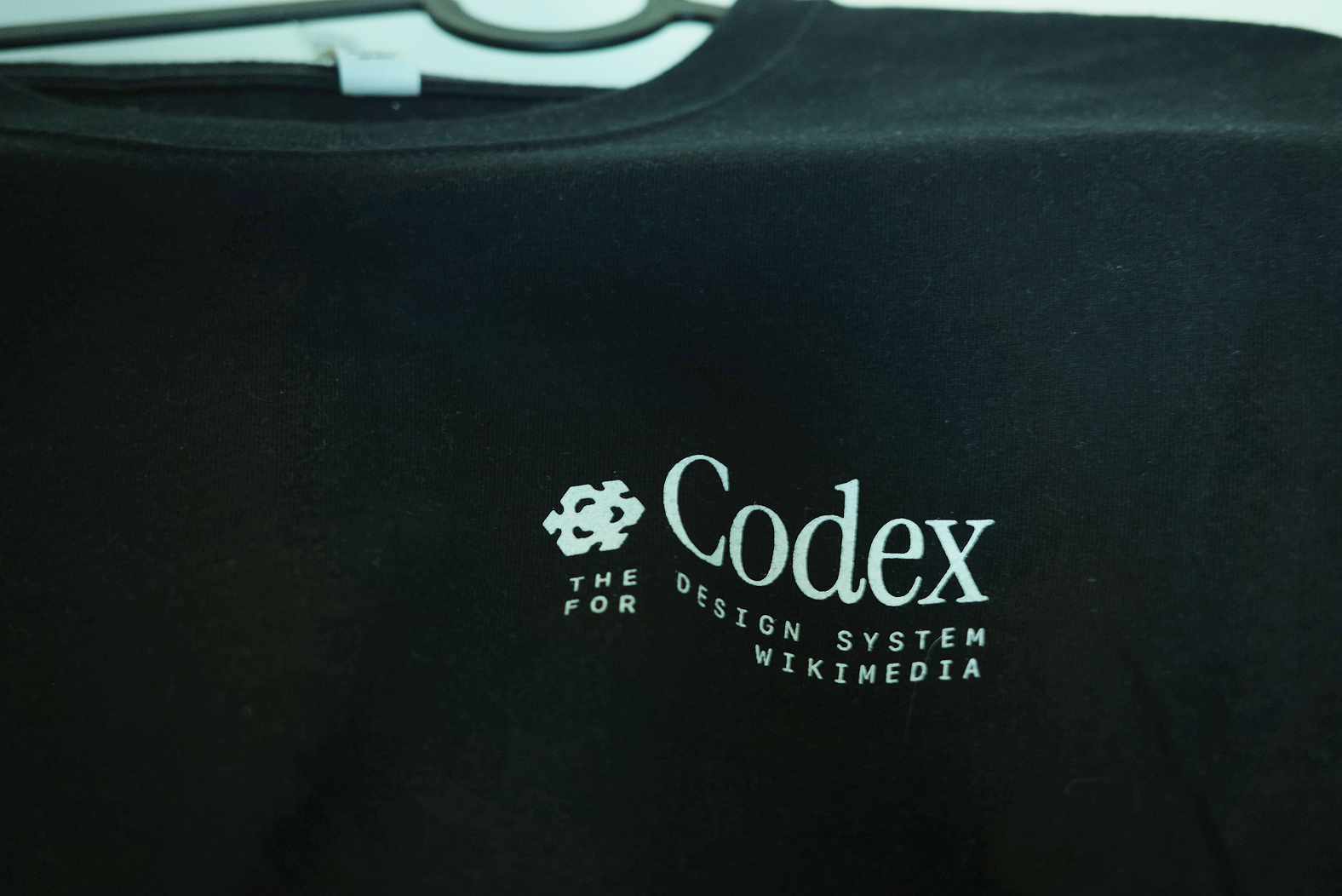 Photograph of a shirt with the Codex logo